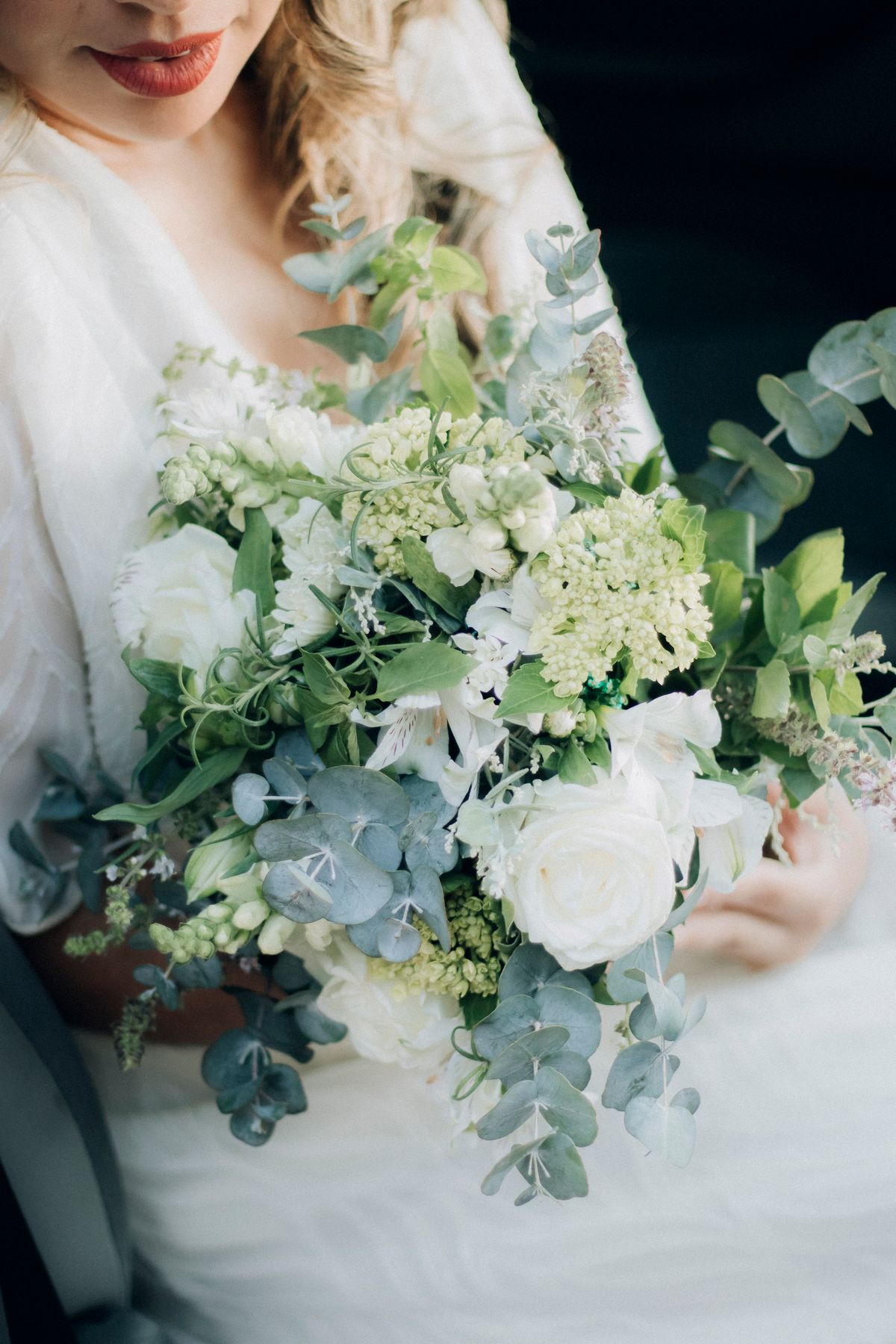 A bouquet of white roses and eucalyptus